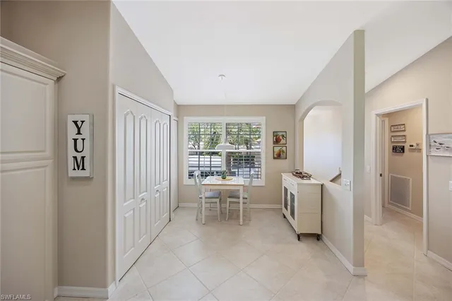 a view of a hallway with living room and dining room