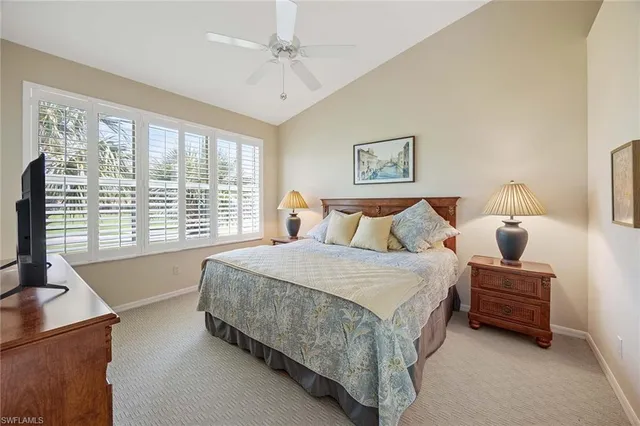 a spacious bedroom with a bed and a large window