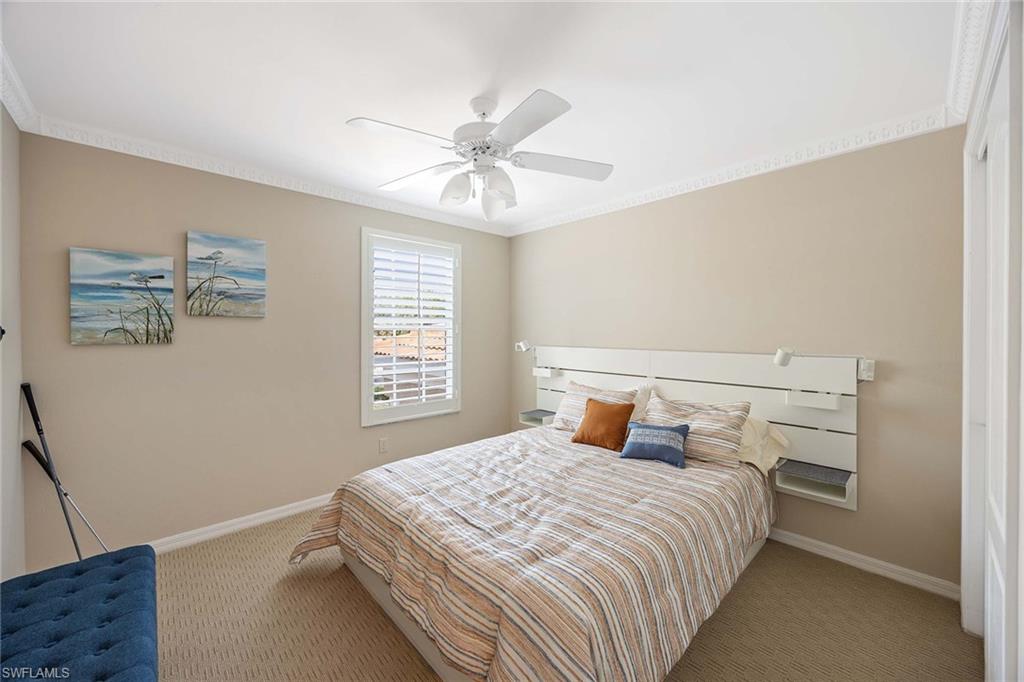 9030 Spring Run Boulevard, Unit 508 Estero, FL 34135 - Photo 18 of 41 a bedroom with a large bed and a chandelier