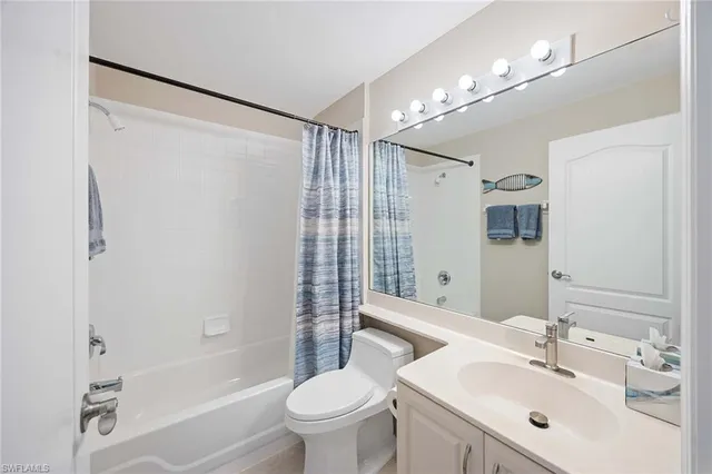 a bathroom with a sink mirror toilet and bathtub