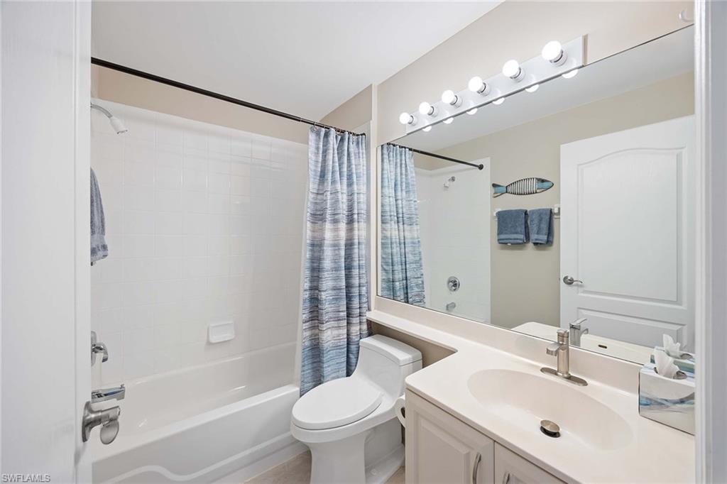 9030 Spring Run Boulevard, Unit 508 Estero, FL 34135 - Photo 19 of 41 a bathroom with a sink mirror toilet and bathtub