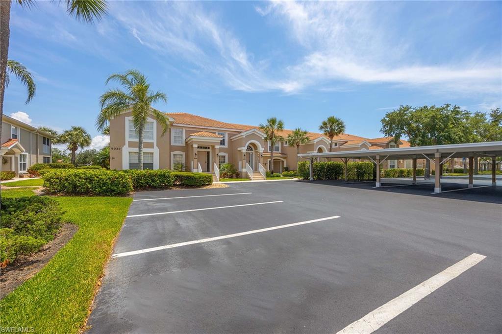 9030 Spring Run Boulevard, Unit 508 Estero, FL 34135 - Photo 2 of 41 a view of a street with houses on both side