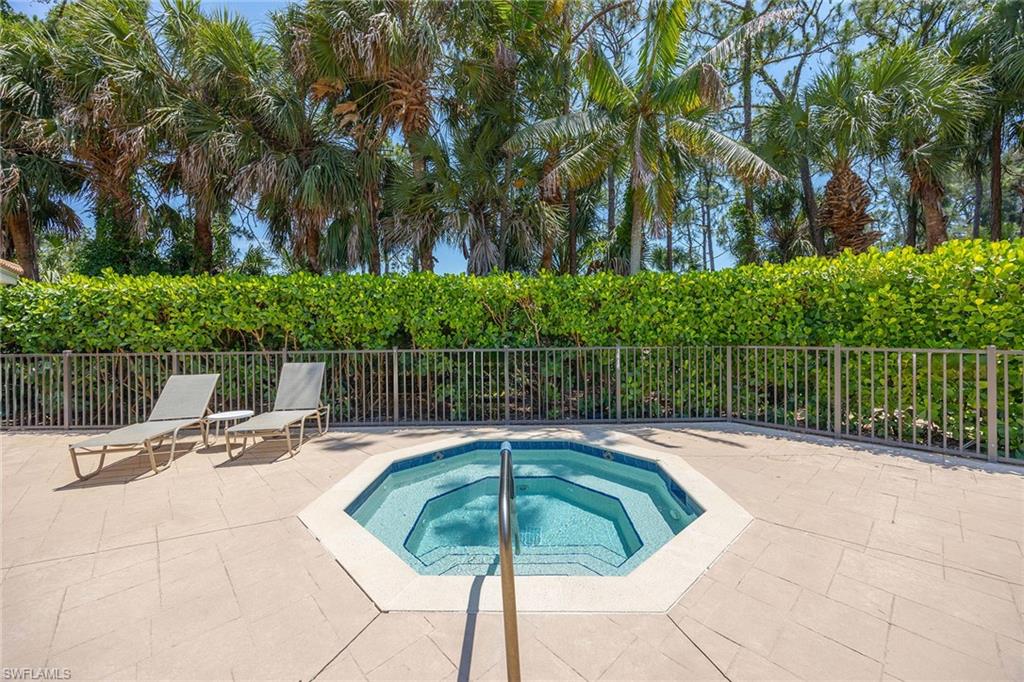 9030 Spring Run Boulevard, Unit 508 Estero, FL 34135 - Photo 27 of 41 a view of a swimming pool with a patio
