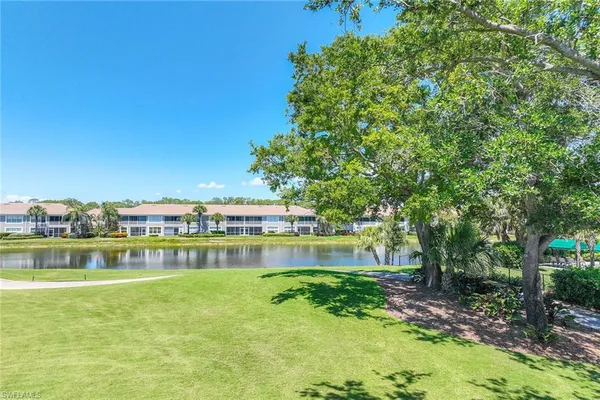 a view of a lake with houses in the back