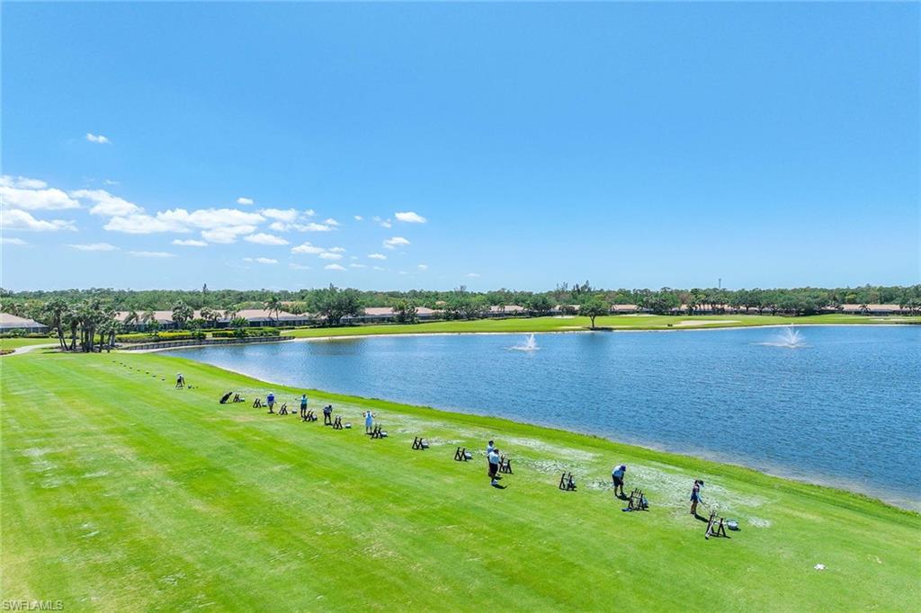 9030 Spring Run Boulevard, Unit 508 Estero, FL 34135 - Photo 41 of 41 a view of a lake with houses in the back