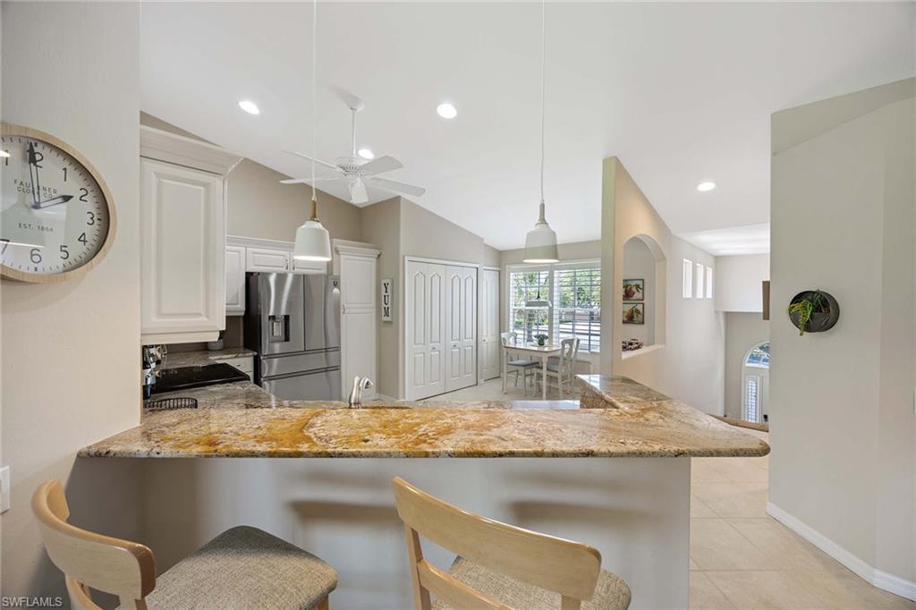 9030 Spring Run Boulevard, Unit 508 Estero, FL 34135 - Photo 10 of 41 a bathroom with a granite countertop sink and a mirror