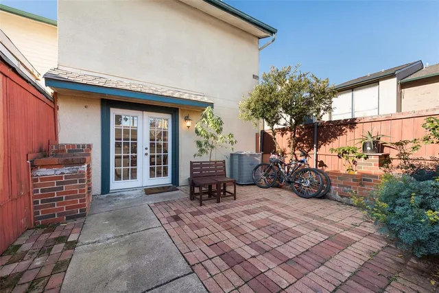 a view of a patio with table and chairs and potted plants