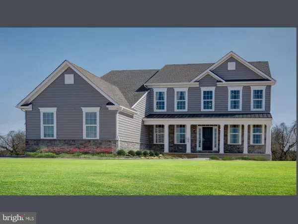 a front view of a house with a garden and yard