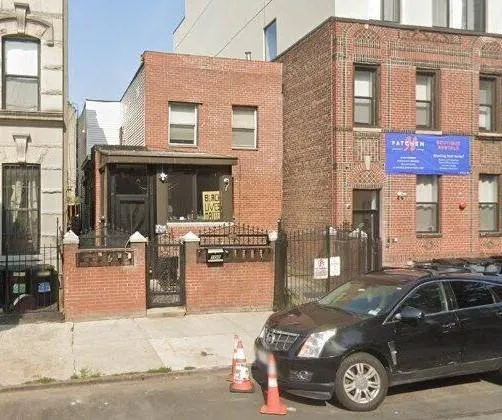 a front view of a house with parking space