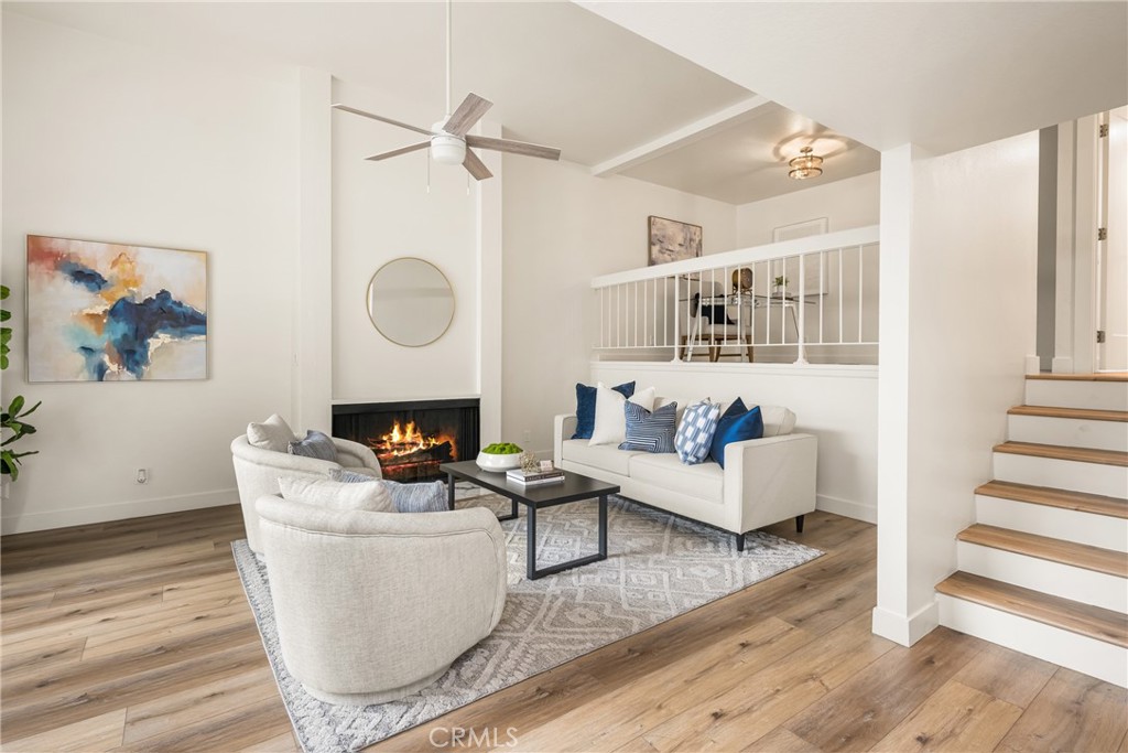 1538 Windsor Lane Fullerton, CA 92831 - Photo 1 of 40 a living room with furniture a fireplace and wooden floor