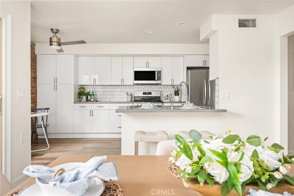 1538 Windsor Lane Fullerton, CA 92831 - Photo 11 of 40 a kitchen with stainless steel appliances granite countertop a white cabinets and a granite counter tops