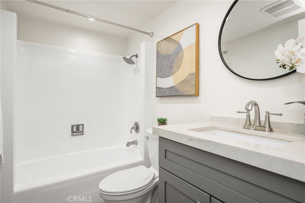 1538 Windsor Lane Fullerton, CA 92831 - Photo 32 of 40 a bathroom with a sink a toilet and a mirror