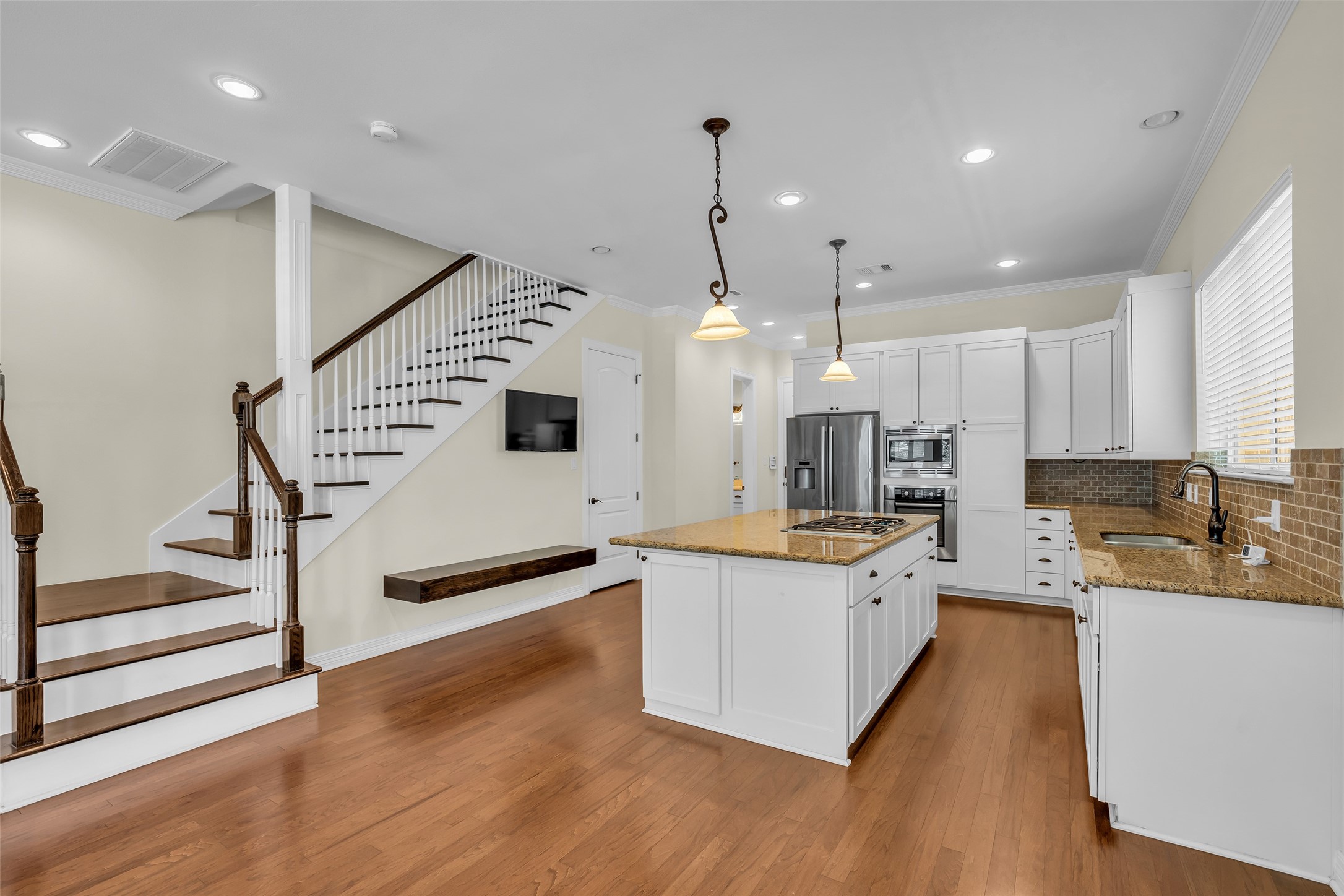 1423 Colorado Street Houston, TX 77007 - Photo 6 of 28 Just off the living area and kitchen is the staircase leading to the second floor, providing convenient access to the upper level.