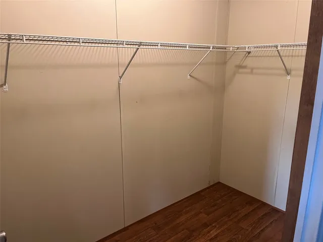 a view of a room with wooden floor