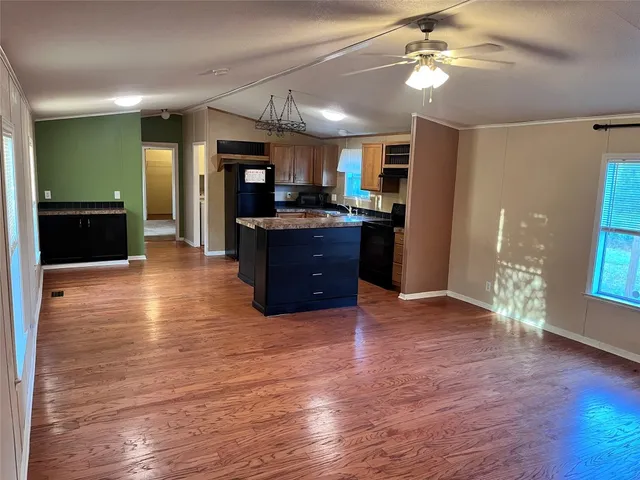 a view of a kitchen with furniture and a ceiling fan