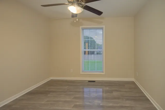 a view of backyard with potted plants and wooden fence