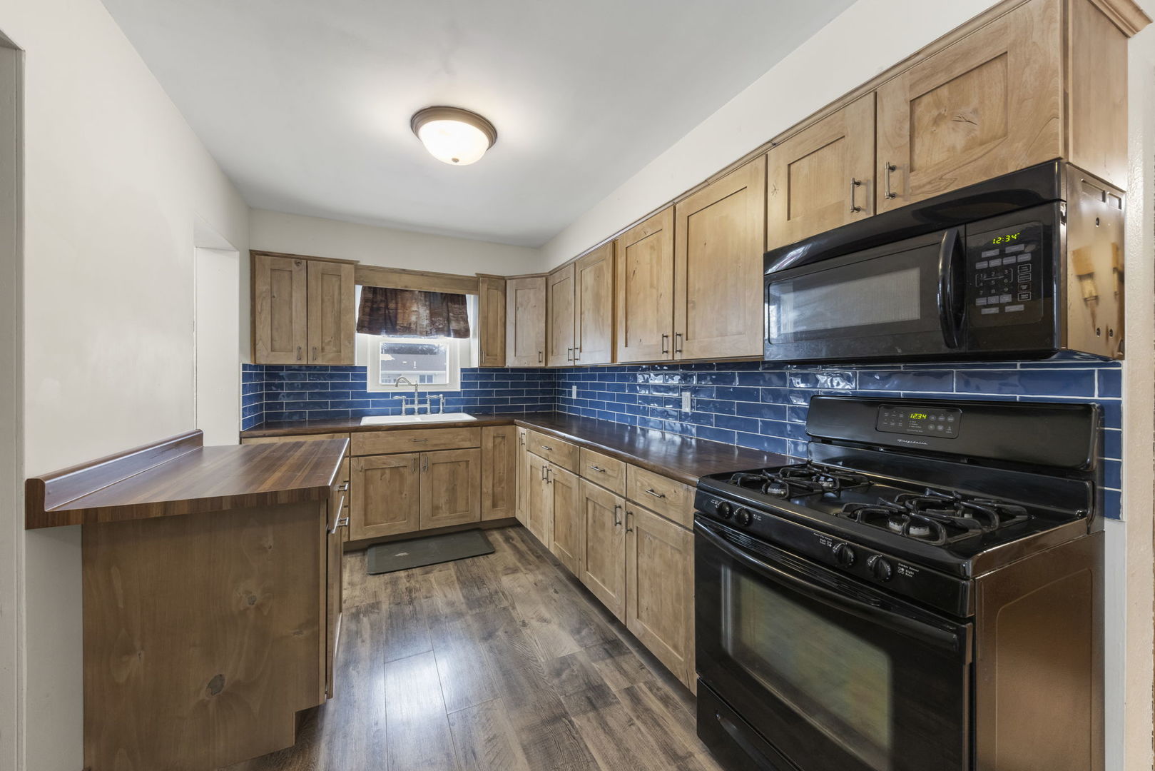 2145 Root Street Crest Hill, IL 60403 - Photo 9 of 34 a kitchen with stainless steel appliances a stove sink microwave and cabinets