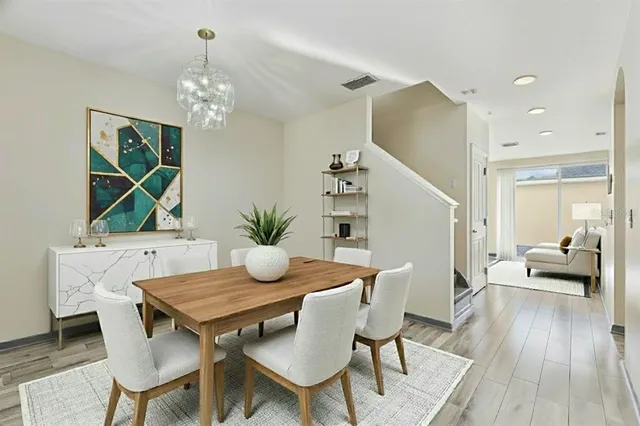 an empty room with wooden floor fan and window