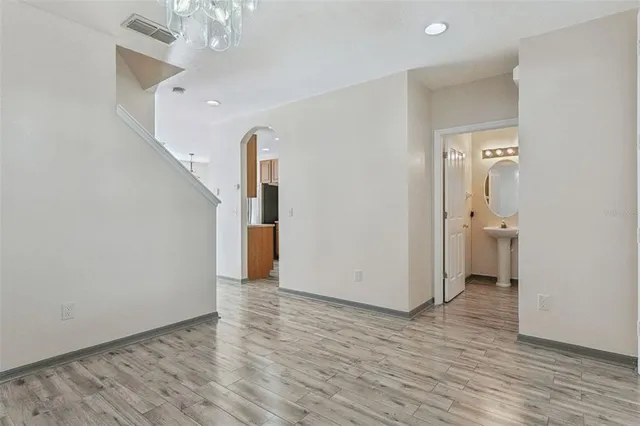 a view of an empty room with wooden floor