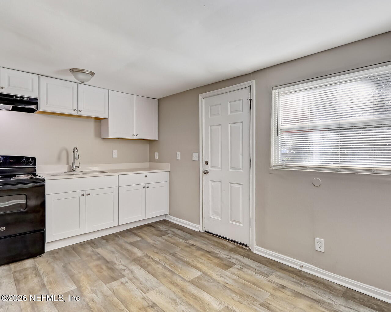 2140 Jayson Avenue Jacksonville, FL 32208 - Photo 11 of 34 a kitchen with granite countertop white cabinets and white appliances