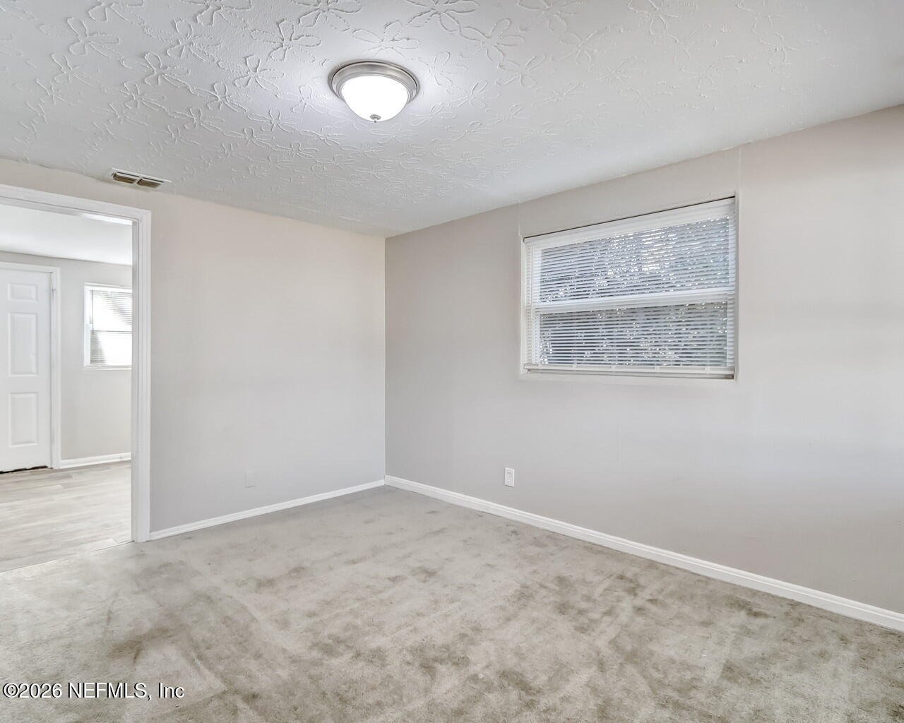 2140 Jayson Avenue Jacksonville, FL 32208 - Photo 6 of 34 an empty room with windows