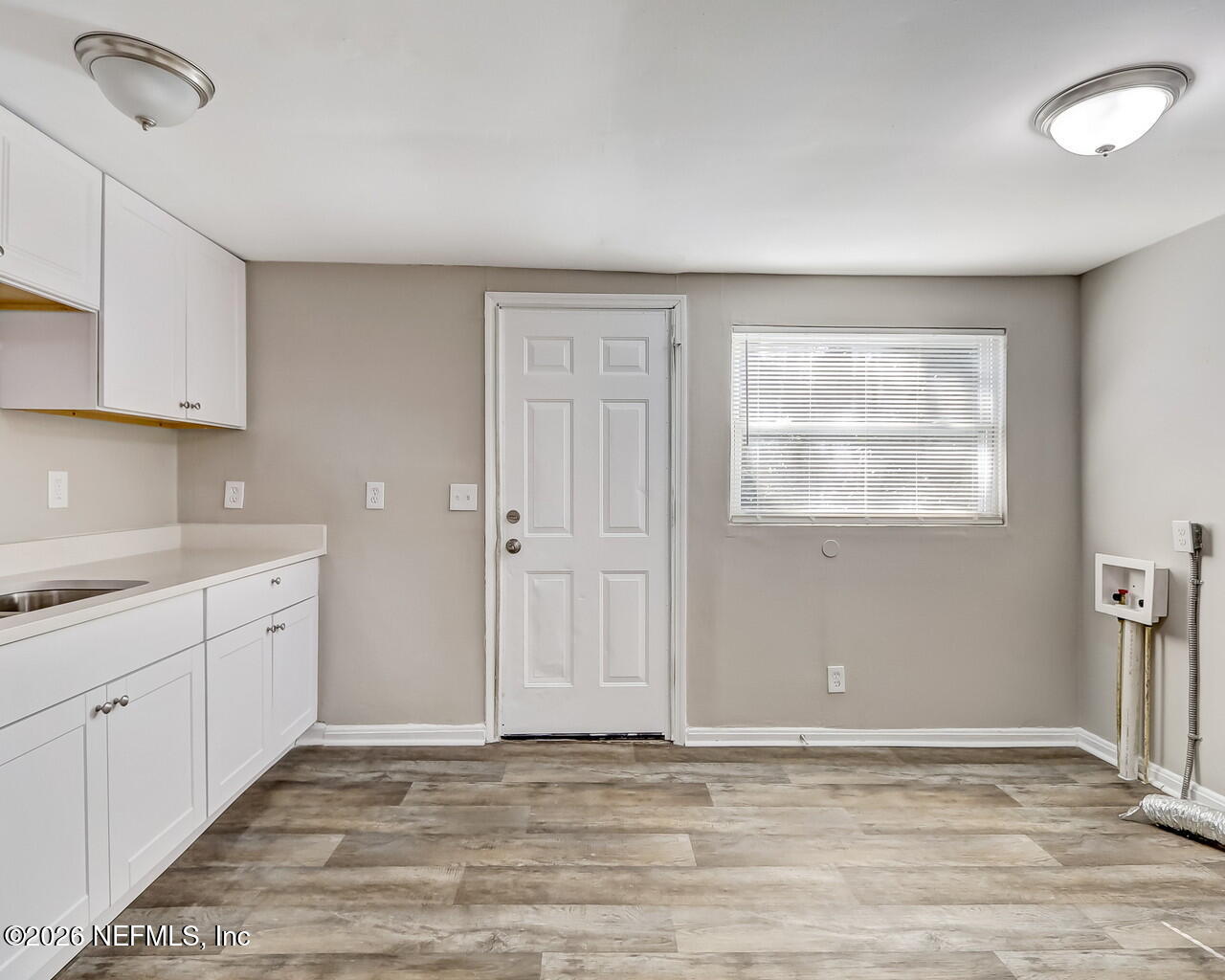 2140 Jayson Avenue Jacksonville, FL 32208 - Photo 10 of 34 a view of an empty room with window and wooden floor