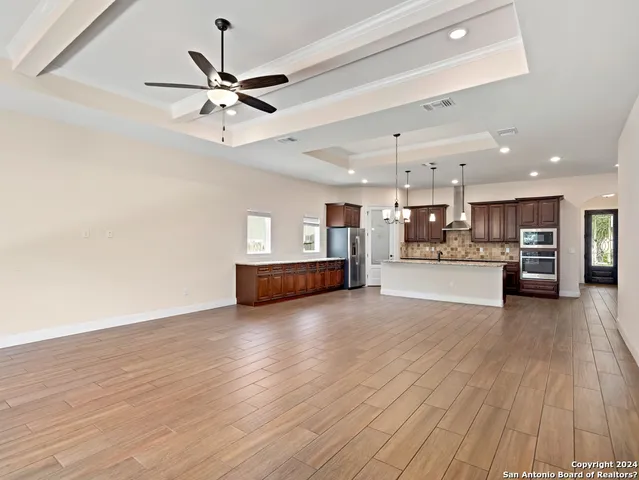 a view of kitchen and hall with wooden floor
