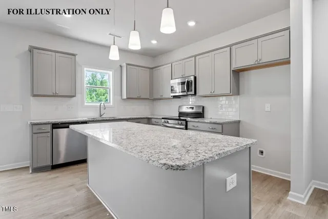 a view of an empty room with wooden floor and fireplace