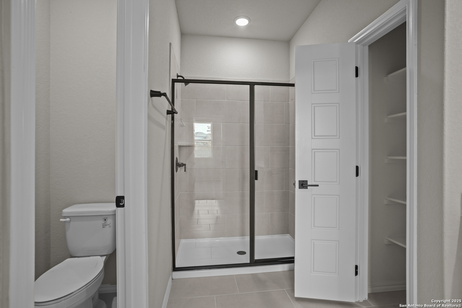 6871 Comanche Cave San Antonio, TX 78233 - Photo 24 of 41 a bathroom with a shower a toilet and sink