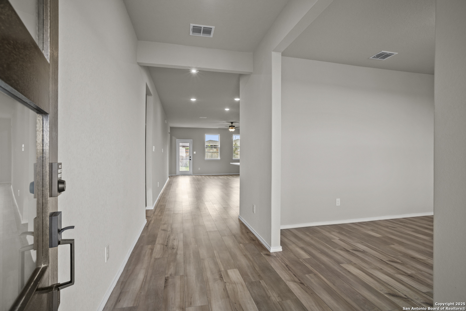 6871 Comanche Cave San Antonio, TX 78233 - Photo 4 of 41 a view of a hallway with wooden floor and staircase