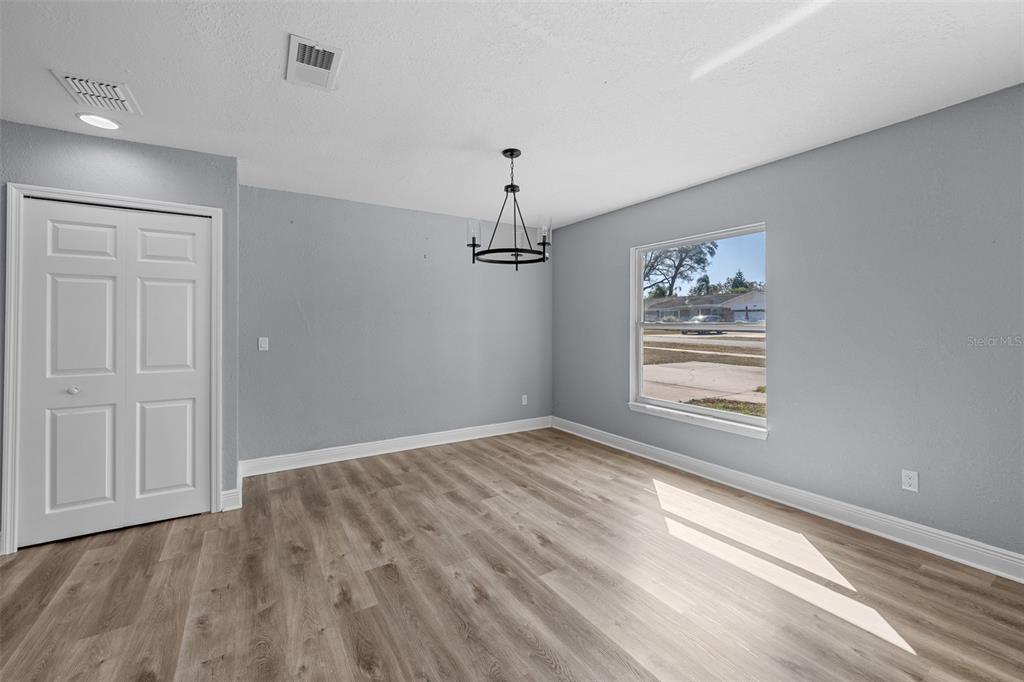606 Bama Road Brandon, FL 33511 - Photo 12 of 44 wooden floor in an empty room with a window