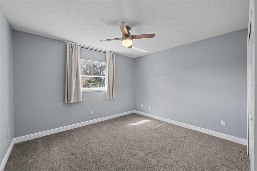 606 Bama Road Brandon, FL 33511 - Photo 28 of 44 an empty room with a window and ceiling fan