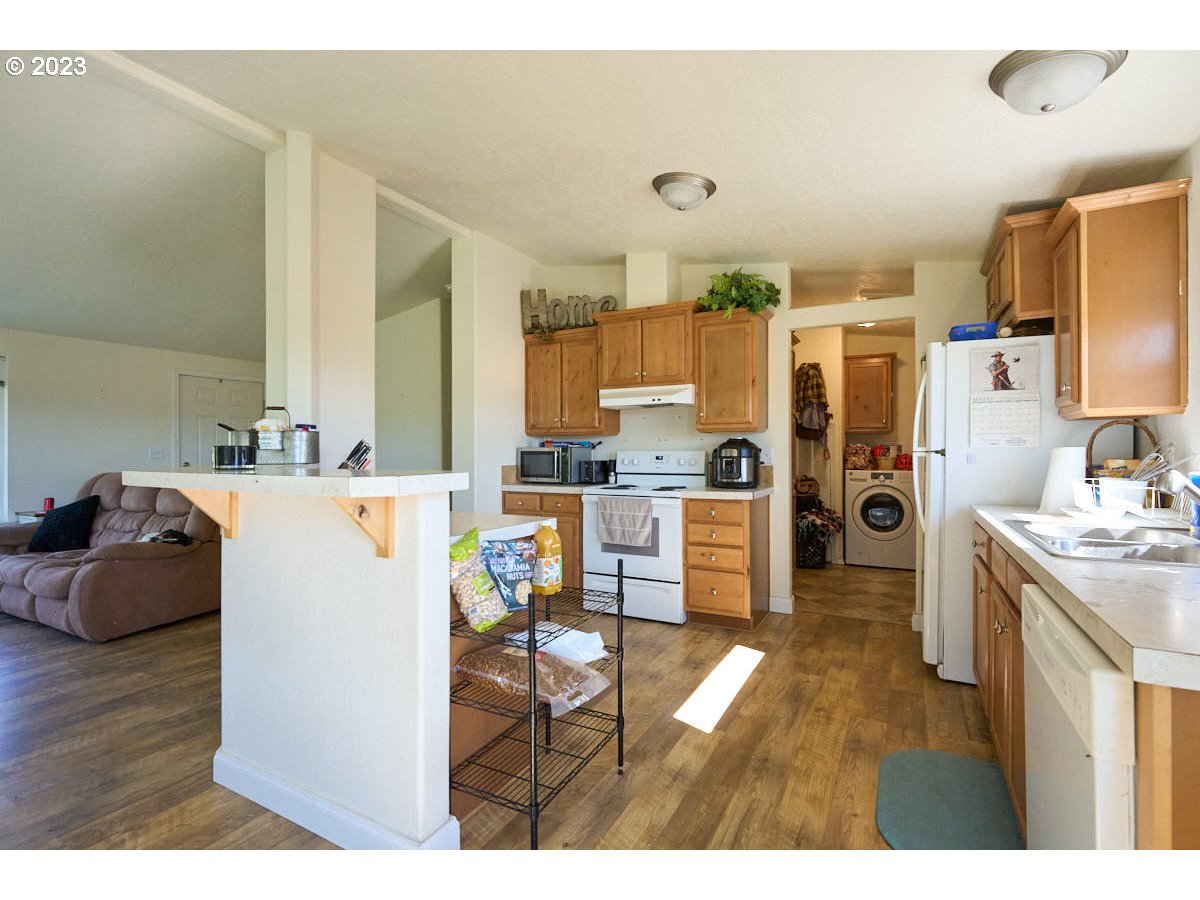 81481 Valley View Road Joseph, OR 97846 - Photo 10 of 24 a kitchen with stainless steel appliances kitchen island granite countertop a refrigerator and a stove
