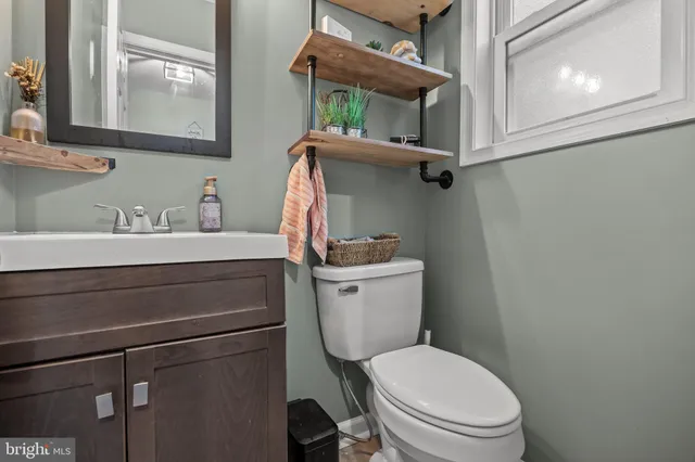 a bathroom with a toilet sink and mirror