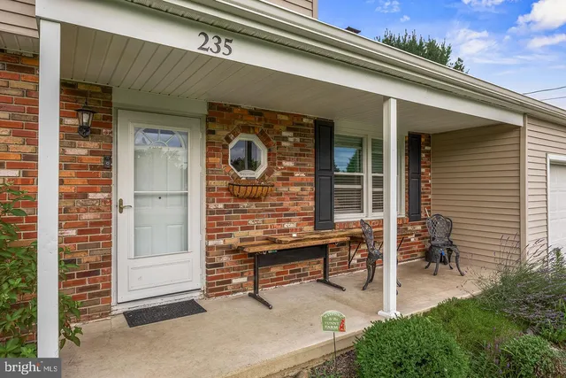 a backyard of a house with outdoor seating