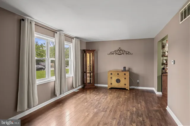 a view of a bedroom with furniture window and wooden floor