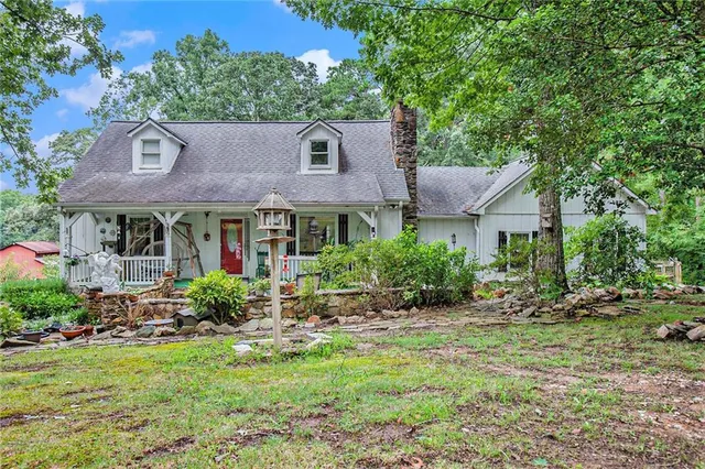 a front view of a house with a yard and porch