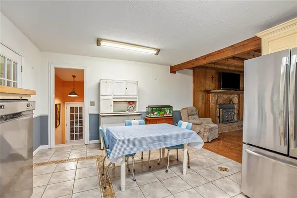 a kitchen with a wooden table and chairs