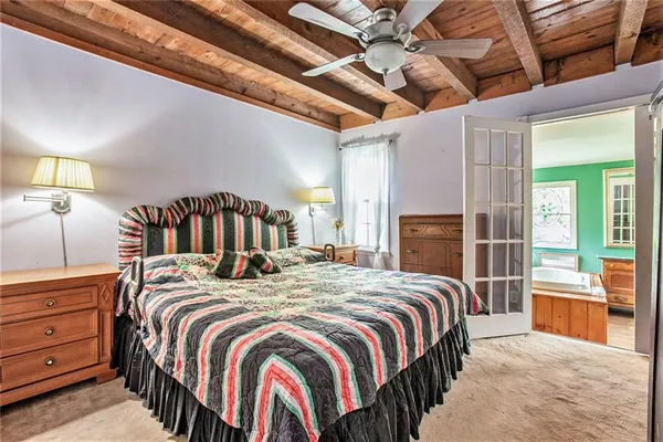 a bed sitting in a bedroom next to a window