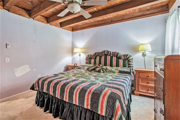 a bedroom with a bed and a lamp