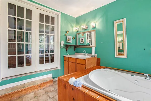 a bathroom with a sink a toilet and a mirror