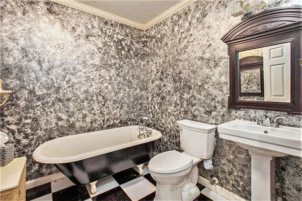 a bathroom with a sink mirror vanity and toilet