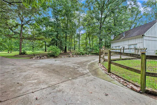 a view of a backyard with large trees