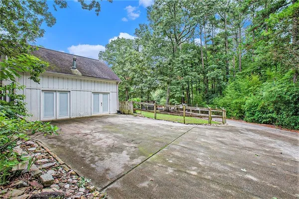 a view of a house with backyard and sitting area