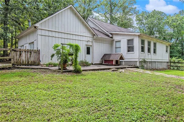 a view of a house with a yard and sitting area