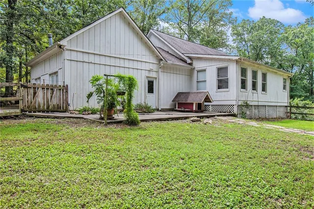 a view of a big yard with plants and trees