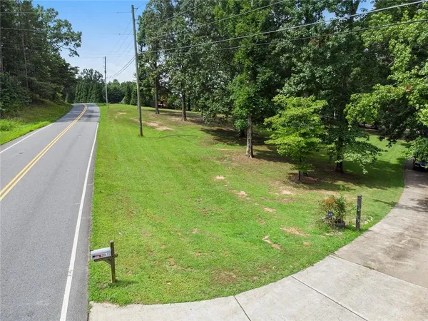 a view of a field with trees in the background