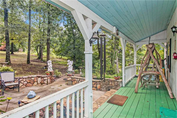 a view of deck with furniture and trees