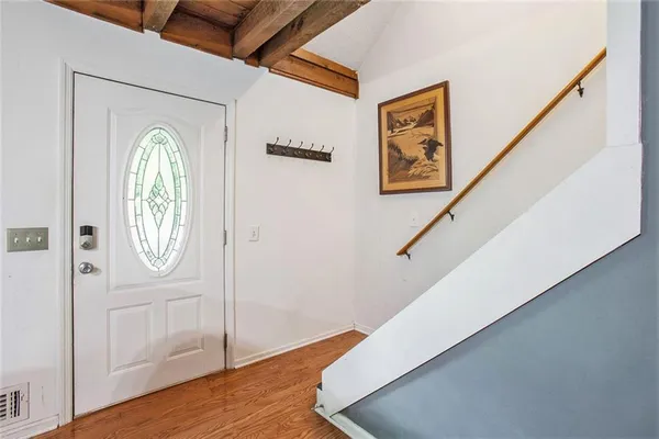 a view of an entryway with wooden floor