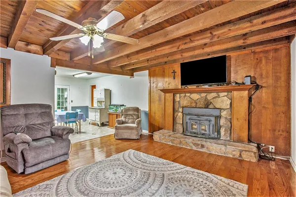 a living room with furniture a flat screen tv and a fireplace